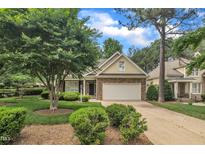 Charming home featuring a brick facade, well-manicured lawn, and an attached two-car garage at 1608 Heritage Links Dr, Wake Forest, NC 27587