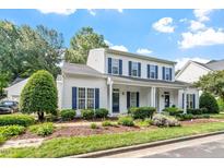 Charming two-story home with a welcoming front porch and beautifully landscaped front yard at 2010 Silky Dogwood Trl, Apex, NC 27502