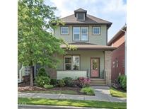 Charming two-story home features a well-maintained lawn, tidy landscaping, and a welcoming pink front door at 2070 Great Ridge Pkwy, Chapel Hill, NC 27516
