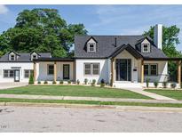 Stunning two-story home featuring a manicured lawn and modern black-and-white design elements at 316 Barbour St, Clayton, NC 27520