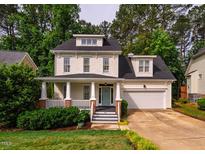 Charming two-story home with a welcoming front porch and manicured lawn, showcasing its curb appeal at 507 Vatersay Dr, Apex, NC 27502