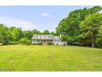 Spacious two-story home with a large, lush front yard and covered porch at 771 Cedar Grove Church Rd, Roxboro, NC 27574