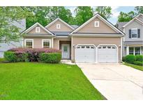 Charming single-story home featuring a well-manicured lawn and a two-car garage at 921 Shefford Town Dr, Rolesville, NC 27571