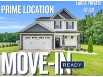 Charming two-story home with a two car garage, landscaping, and a large, private lot is move-in ready at 97 Arapahoe Dr, Kenly, NC 27542