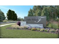 Landscaped community sign on a sunny day with beautiful trees and flowers at 1107 Masters Place Way # 155, Durham, NC 27703