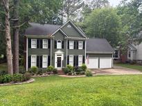 Charming two-story home boasts a two-car garage, neat landscaping, and a welcoming front entrance at 118 Merry Hill Dr, Cary, NC 27518