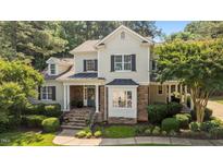 Charming two-story home featuring stone accents, a bay window, and a well-manicured lawn at 1420 Heritage Links Dr, Wake Forest, NC 27587