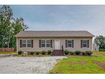 Inviting single-story home features a charming entrance and well-maintained landscaping at 153 Bywood Dr, Roxboro, NC 27573
