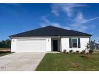 Charming single-story home with a two-car garage, manicured lawn, and a classic black and white color scheme at 16 Vale Spring Ln, Lillington, NC 27546