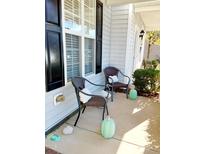 Cozy front porch area with seating and charming decorations, perfect for relaxing outdoors at 1633 Snow Mass Way, Durham, NC 27713