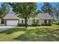 Charming single-story home featuring a brick and vinyl exterior, well-manicured lawn, and attached two-car garage at 169 Clearwater Harbor Hbr, Sanford, NC 27332