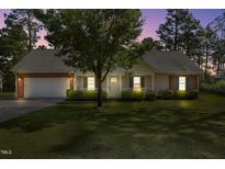 Charming single-story home with manicured lawn, inviting entrance and attached two car garage at 169 Clearwater Harbor Hbr, Sanford, NC 27332