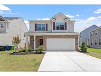 Charming two-story home featuring a two-car garage, well-manicured lawn, and beautiful brick and siding exterior at 2208 Seneca Dr, Raleigh, NC 27604
