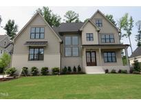 A beautiful two-story home with neutral colors, black window trim, and well-manicured front yard at 2577 Silas Peak Ln, Apex, NC 27523