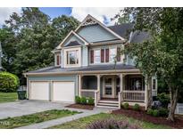 Charming home with a welcoming porch and two-car garage in a beautiful, tree-lined neighborhood at 2617 Charenson Pl, Raleigh, NC 27614
