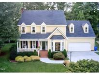 Charming two-story home with a manicured lawn, brick walkway, and attached two car garage at 2645 Ridgewell Ct, Raleigh, NC 27613