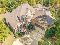 Stunning aerial view of a two-story home with lush landscaping and a spacious driveway at 268 The Preserve Trl, Chapel Hill, NC 27517