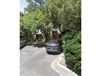 Charming two-story home with red door nestled among lush greenery and a parking area at 300 Cedarwood Ln, Carrboro, NC 27510