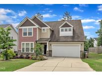 Charming two-story home featuring a spacious driveway and attached garage at 3413 Fairstone Rd, Wake Forest, NC 27587