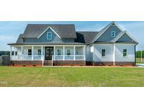 Inviting home features a covered front porch and well-manicured lawn, providing great curb appeal at 3417 Aspen Rd, Rocky Mount, NC 27804