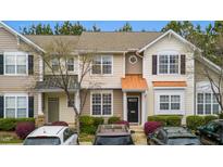 Charming townhome featuring neutral siding, black front door, and manicured landscaping at 4114 Brenmar Ln, Durham, NC 27713