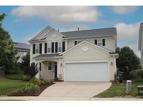 Charming two-story home with a two-car garage, complimented by a well-manicured lawn at 412 Ashdale Dr, Fuquay Varina, NC 27526