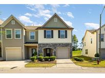Charming two-story townhouse with a stone facade and attached garage at 5031 Eagle Stone Ln, Raleigh, NC 27610