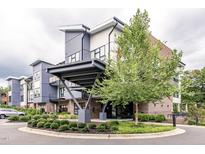 Modern apartment building with a gray and white exterior, landscaped circle drive, and covered entrance at 515 N Churton St # Ste 201, Hillsborough, NC 27278