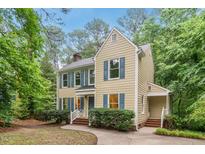 Charming two-story home with blue shutters surrounded by lush greenery and a well-maintained yard at 5315 Fortunes Ridge Dr, Durham, NC 27713