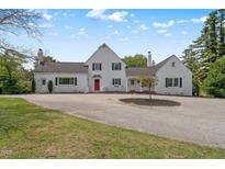 Charming exterior view of a large, white home featuring a red front door and well-maintained landscaping at 70 S Patterson St, Coats, NC 27521
