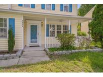 Charming home featuring a covered front porch and blue shutters at 7024 Beaverwood Dr, Raleigh, NC 27616