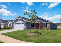 Charming single-Gathering home featuring a red front door, well-manicured lawn, and attached two-car garage at 75 Springwood Ln, Franklinton, NC 27525