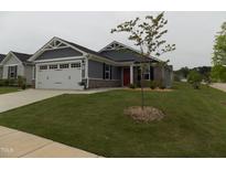 Charming single-story home with a manicured lawn, a two-car garage, and stone facade accents at 75 Springwood Ln, Franklinton, NC 27525