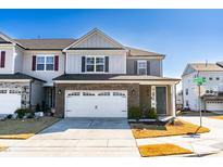 Charming two-story home with a brick facade, a two-car garage, and a well-manicured lawn at 931 Haybeck Ln, Apex, NC 27523
