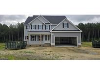Two-story home featuring a spacious garage and classic gray siding at 98 Sanders Farm Drive, Smithfield, NC 27577