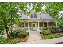 Charming two-story home with a welcoming front porch and landscaped yard, perfect for outdoor relaxation and curb appeal at 102 Newell St, Chapel Hill, NC 27516