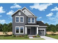 Charming two-story home with gray siding, white trim, and a well-manicured front lawn at 104 Restful Pt, Fuquay Varina, NC 27526