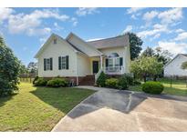 Charming single Gathering home with landscaped yard and inviting front porch at 1211 Azalea Dr, Zebulon, NC 27597