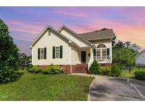 Charming one-story home with vinyl siding, green shutters and a well-manicured front yard at 1211 Azalea Dr, Zebulon, NC 27597