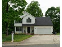 Charming two-story home features a well-maintained lawn and a two-car garage at 1333 Beaufort Dr, Graham, NC 27253