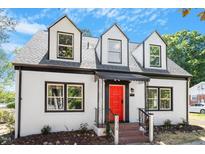 Charming two-story home featuring a bright red front door and well-maintained landscaping at 134 Nelson St, Durham, NC 27707