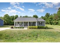 Charming one-story home with inviting front porch and well-maintained lawn and landscaping at 18 Hunter Fox Trl, Angier, NC 27501
