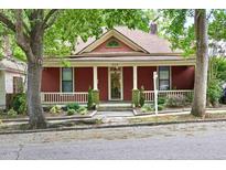 Charming red house with a cozy front porch and well-maintained landscaping at 304 Linden Ave, Raleigh, NC 27601