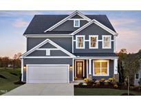 Charming two-story home with gray siding, a garage, and a beautifully landscaped front yard at 361 Murray Grey Ln, Wake Forest, NC 27587