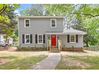 Charming two-story home with gray siding, black shutters, and a bright red front door at 3700 Summer Pl, Raleigh, NC 27604