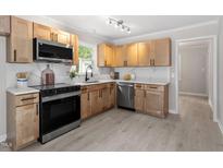An updated kitchen with stainless steel appliances and modern cabinetry at 3700 Summer Pl, Raleigh, NC 27604