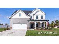 Charming two-story home with a covered porch, attached garage, and well-manicured lawn at 436 Longleaf Glen Lane, Zebulon, NC 27597