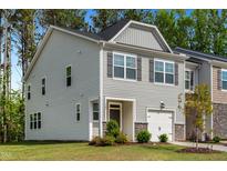 Charming gray two-story home with a one-car garage and well-maintained landscaping at 501 Hazy Hills Ln, Garner, NC 27529