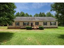 Charming single-story home featuring a wheelchair ramp and landscaped front yard with mature trees at 921 Sweet Raspberry Lane Ln, Lillington, NC 27546