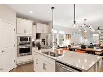 This is a well-appointed kitchen with stainless steel appliances, a granite countertop, and pendant lighting at 1008 Sounding Ln, Durham, NC 27703